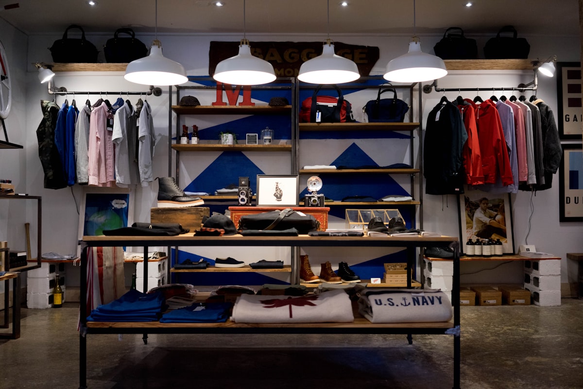 Curated retail store interior with apparel displays and pendant lighting
